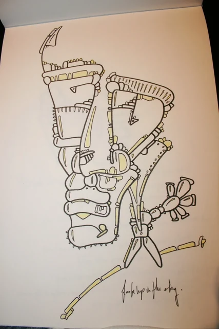 A tall outlined face-like figure on a sketchbook page.